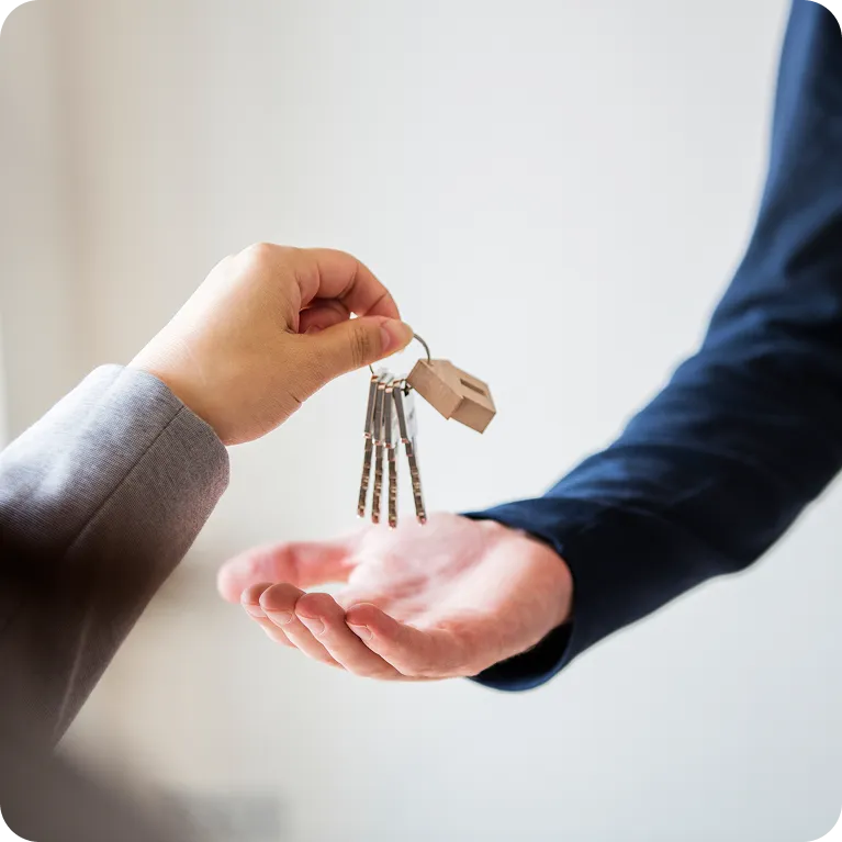 Person handing over house keys